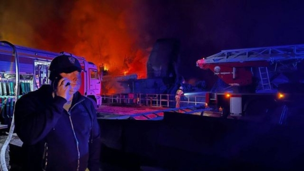 Mikhail Razvozhayev in front of fire